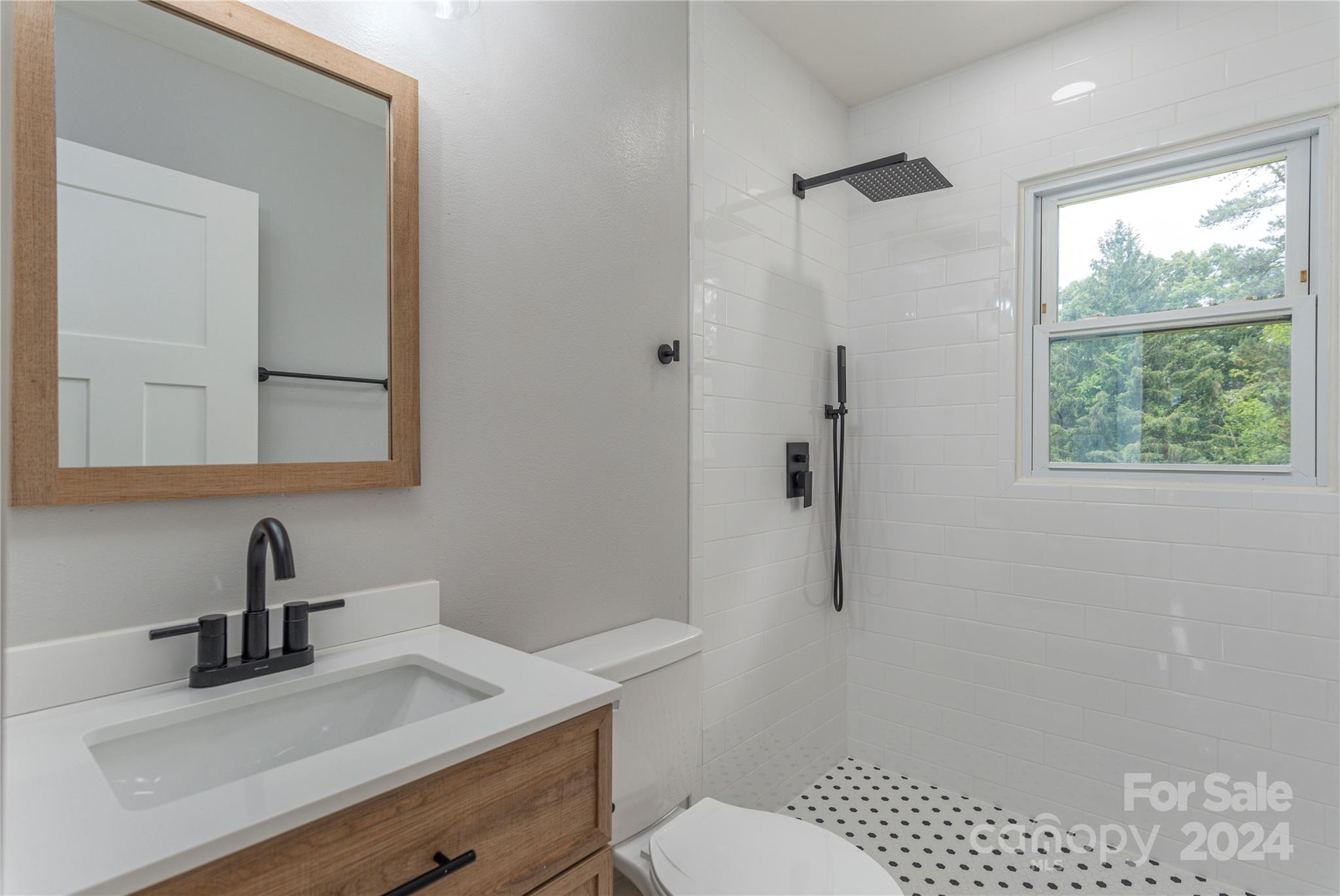 1045 North Canton Road Canton, NC 28716 - Photo 20 of 26 a bathroom with a sink toilet and window