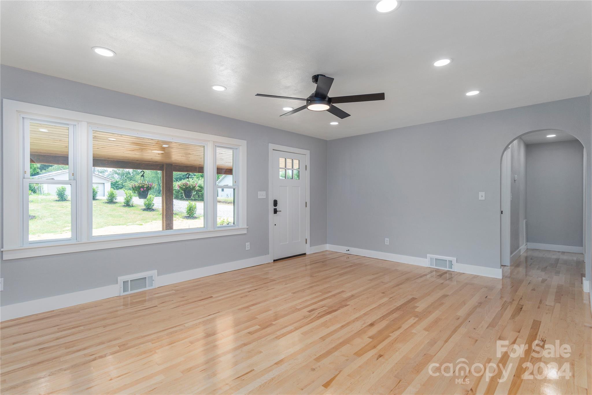 1045 North Canton Road Canton, NC 28716 - Photo 5 of 26 a view of an empty room with a window