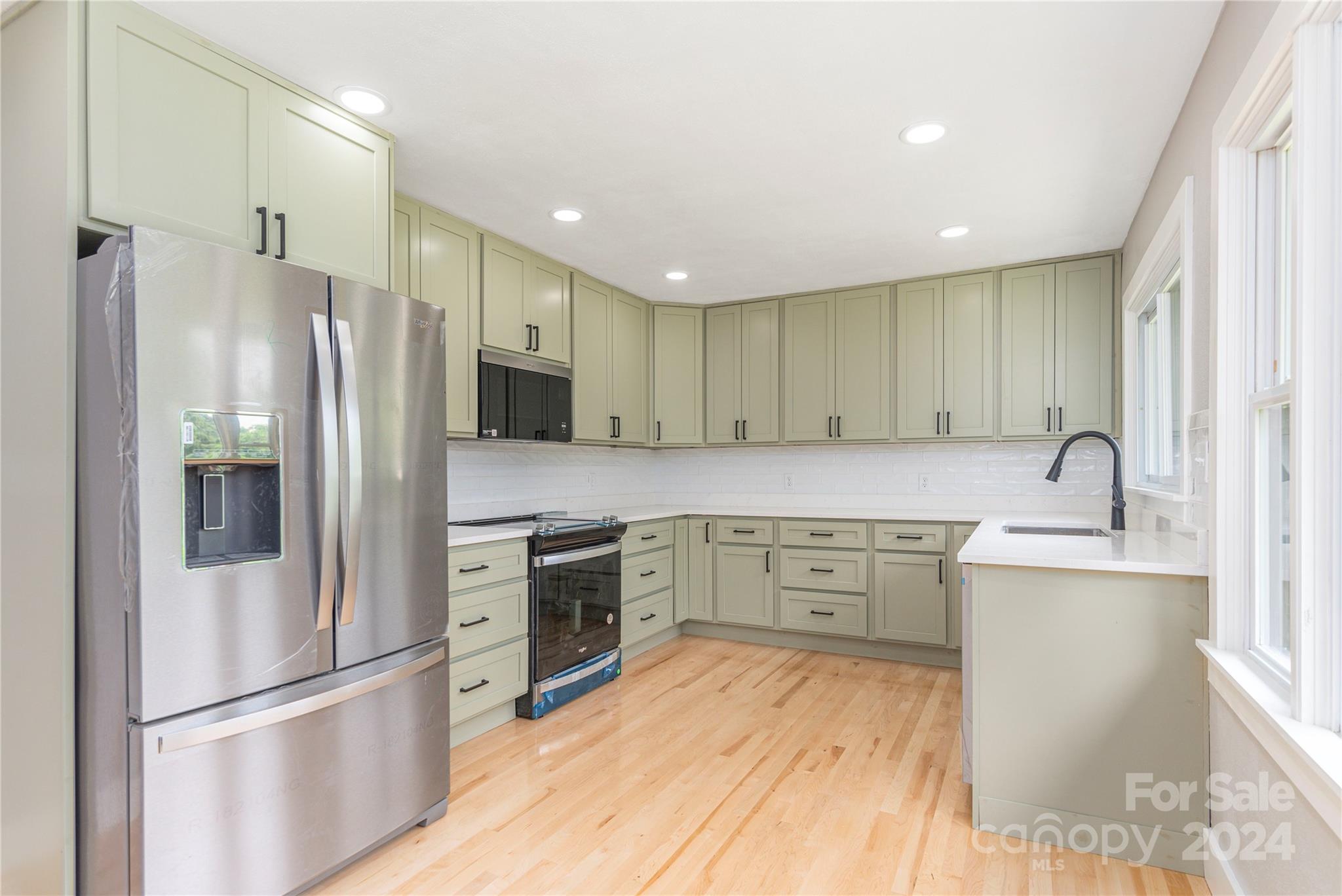 1045 North Canton Road Canton, NC 28716 - Photo 6 of 26 a kitchen with a refrigerator stove and sink