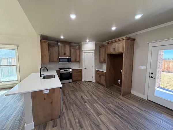 a kitchen with a table chairs refrigerator and cabinets