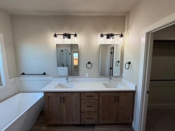 a bathroom with a double vanity sink and a mirror
