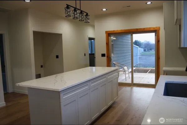 a kitchen with stainless steel appliances a sink stove and cabinets