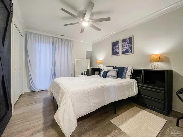 a bedroom with a bed and a chandelier