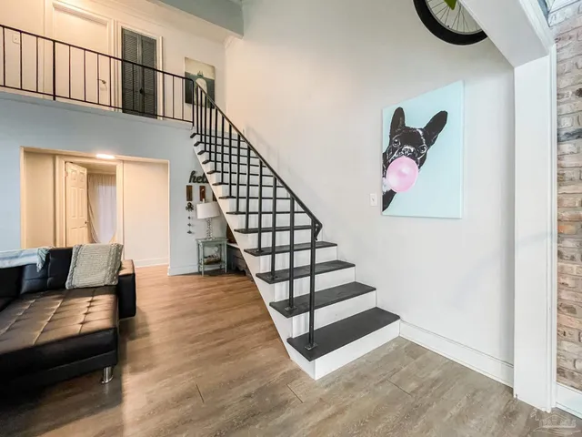 a view of entryway and hall with wooden floor
