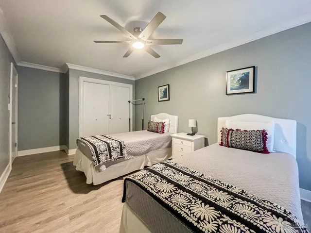 a bedroom with two beds and painting on the wall