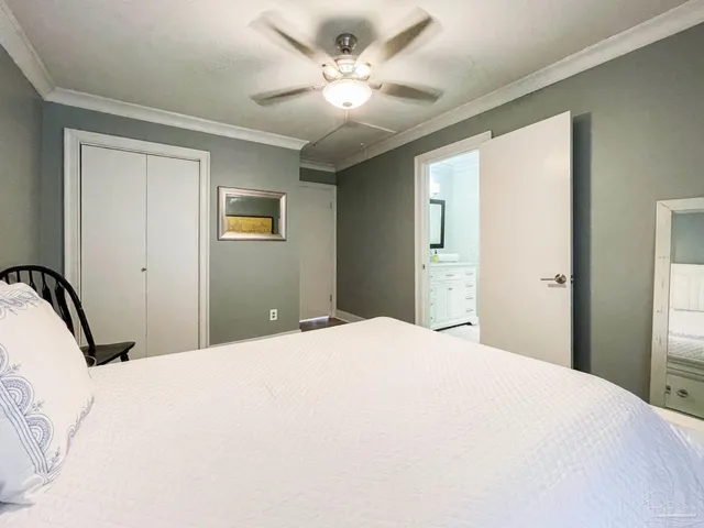 a bedroom with a large bed and a chandelier