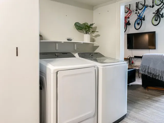a view of washer and dryer with wooden floor