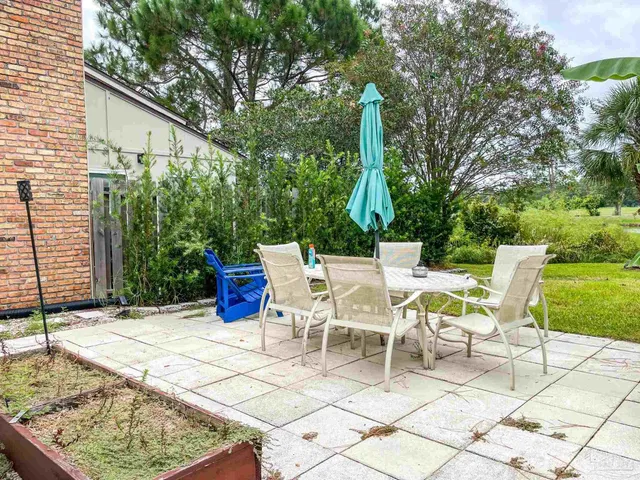 a view of an chairs and tables in the backyard