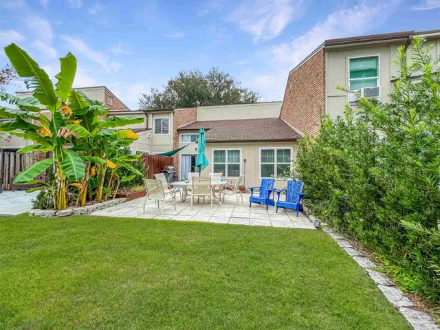 a view of a house with backyard porch and sitting area