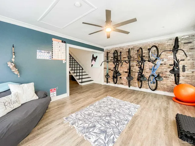 a view of a livingroom with wooden floor and furniture