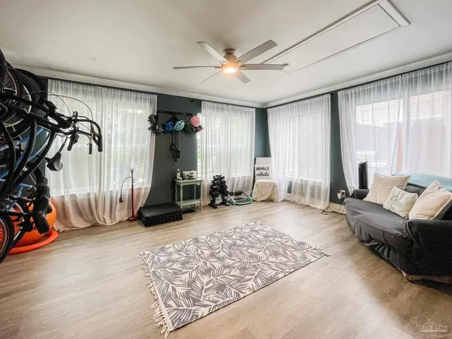 a very nice looking room with gym equipment and a large window