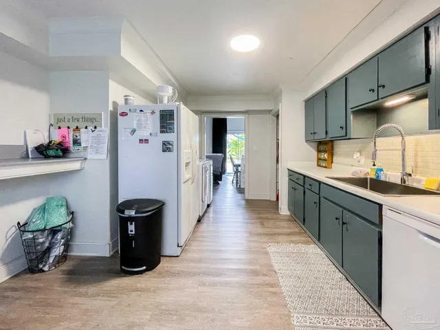 a large kitchen with stainless steel appliances granite countertop a refrigerator and a sink