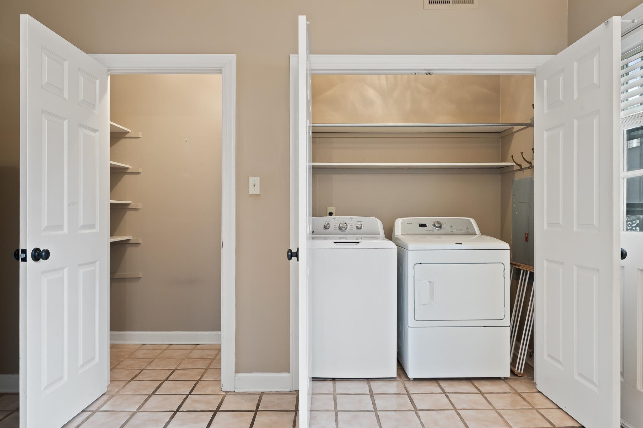 1683 Kimbrough Road Germantown, TN 38138 - Photo 13 of 34 Laundry area featuring washing machine and clothes dryer and light tile patterned flooring