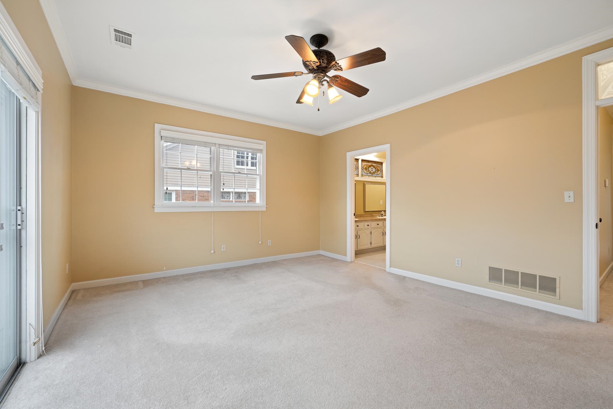1683 Kimbrough Road Germantown, TN 38138 - Photo 16 of 34 Unfurnished bedroom featuring ornamental molding, light colored carpet, ceiling fan, and ensuite bath