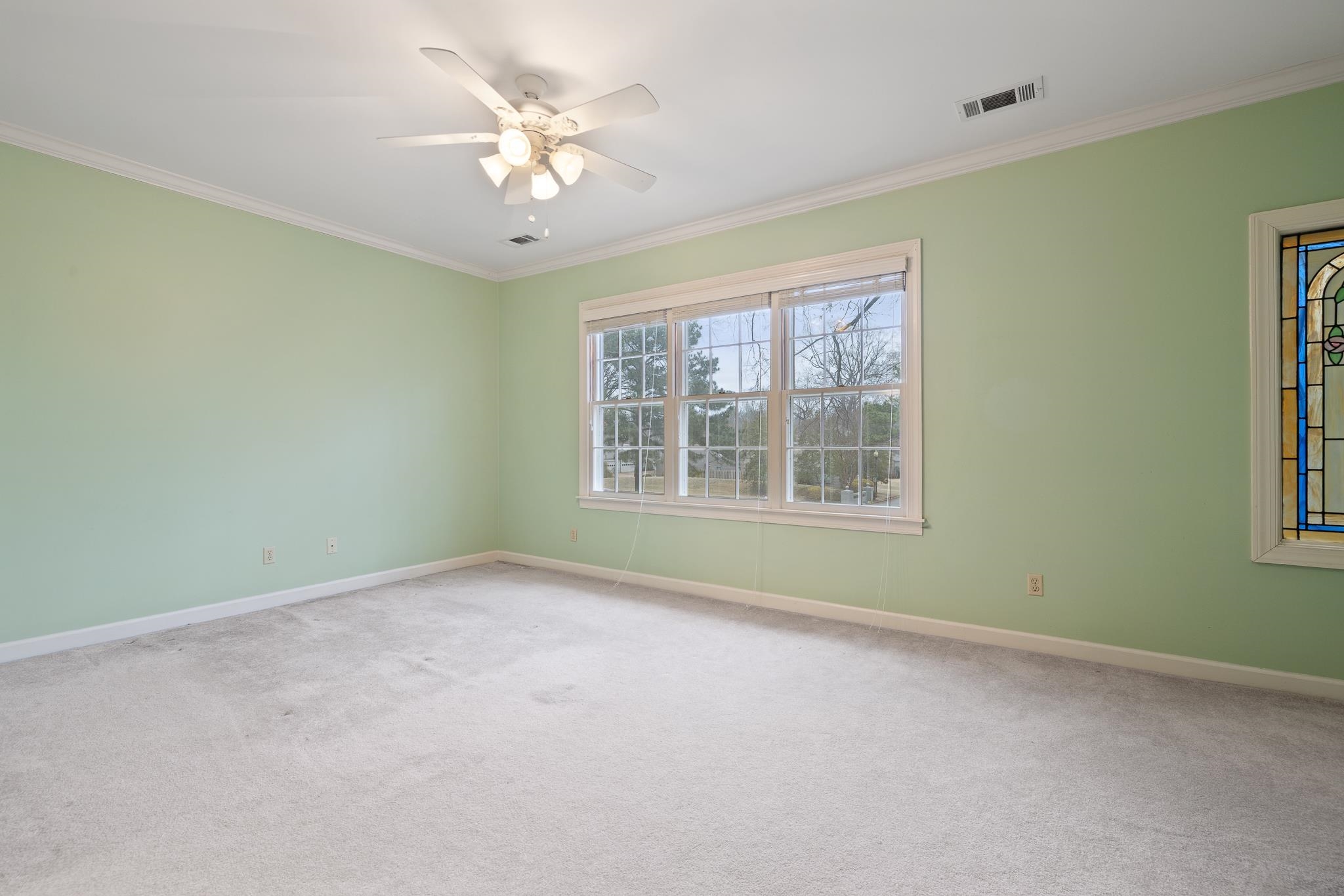 1683 Kimbrough Road Germantown, TN 38138 - Photo 20 of 34 Carpeted spare room featuring ornamental molding and a ceiling fan