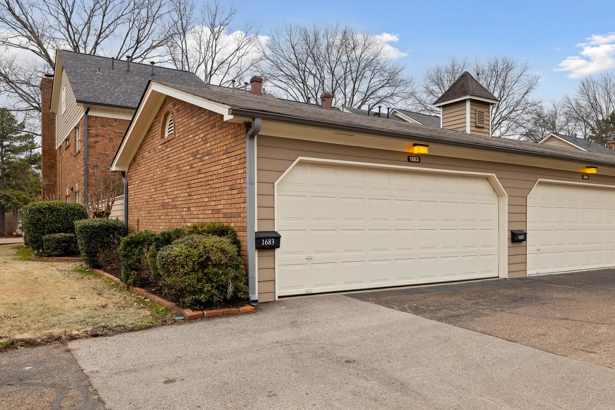 1683 Kimbrough Road Germantown, TN 38138 - Photo 25 of 34 View of side of property with brick siding, a shingled roof, and community garages