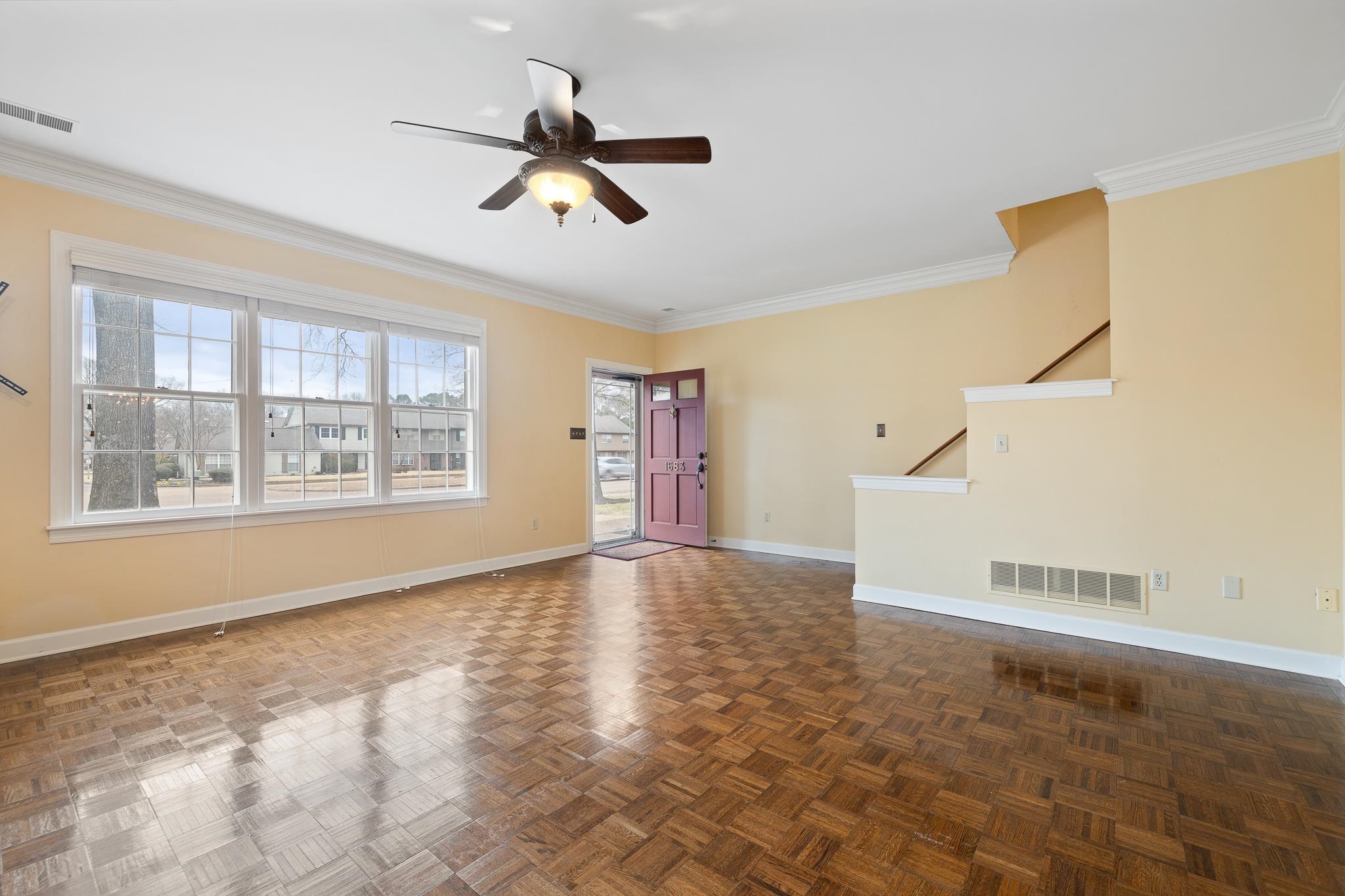 1683 Kimbrough Road Germantown, TN 38138 - Photo 3 of 34 Unfurnished living room with parquet floors, ceiling fan, healthy amount of natural light, and ornamental molding