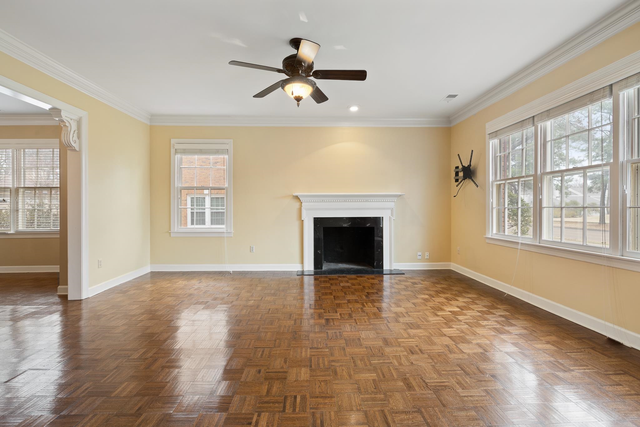 1683 Kimbrough Road Germantown, TN 38138 - Photo 4 of 34 Unfurnished living room featuring parquet floors, a ceiling fan, ornamental molding, and a high end fireplace