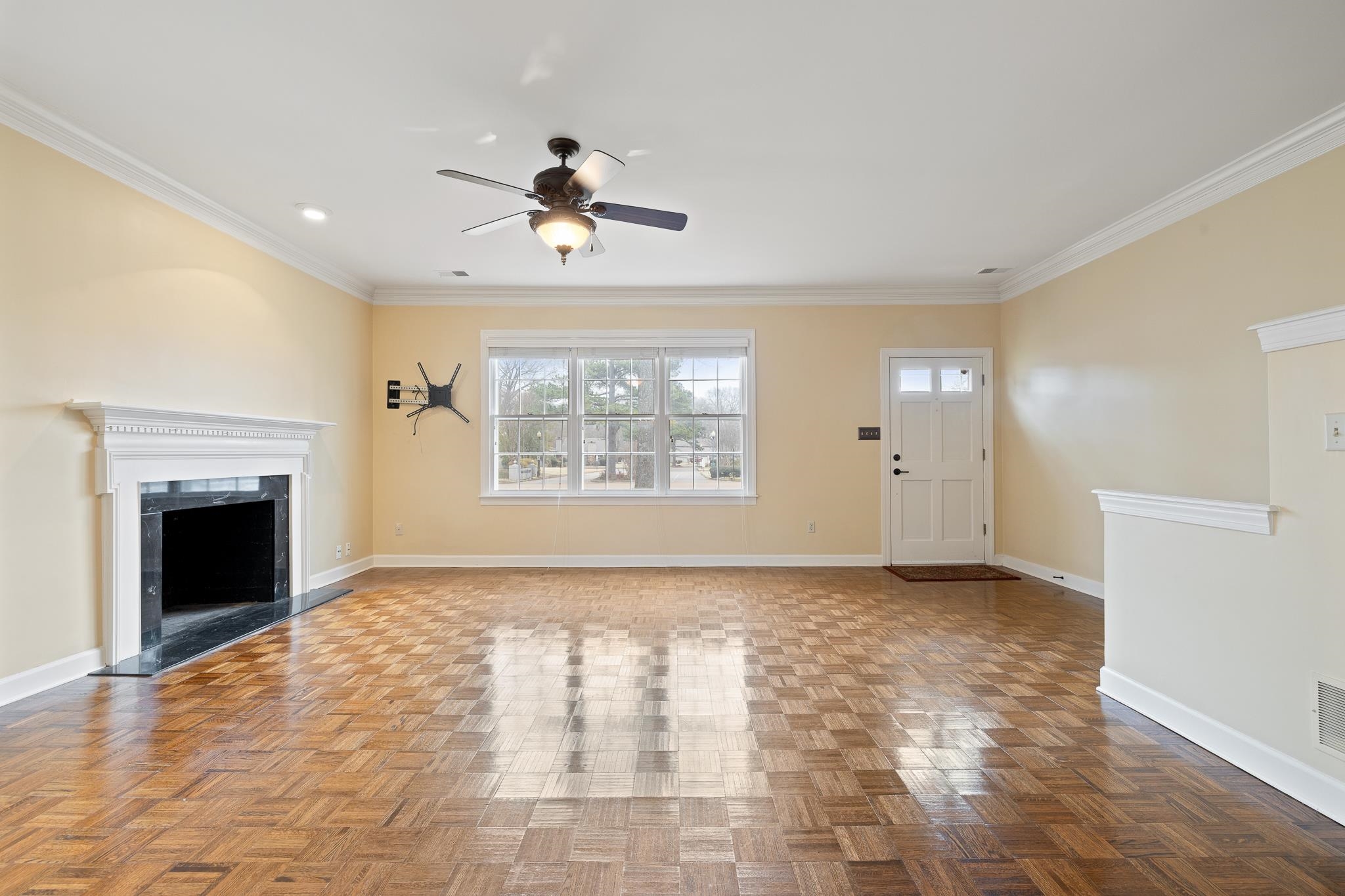1683 Kimbrough Road Germantown, TN 38138 - Photo 5 of 34 Unfurnished living room with ceiling fan, parquet flooring, ornamental molding, and a high end fireplace