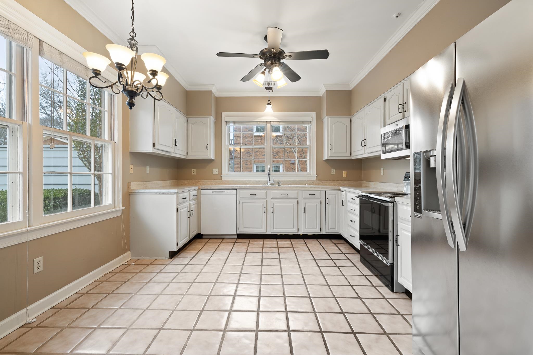 1683 Kimbrough Road Germantown, TN 38138 - Photo 10 of 34 Kitchen with stainless steel appliances, light countertops, white cabinetry, crown molding, and ceiling fan