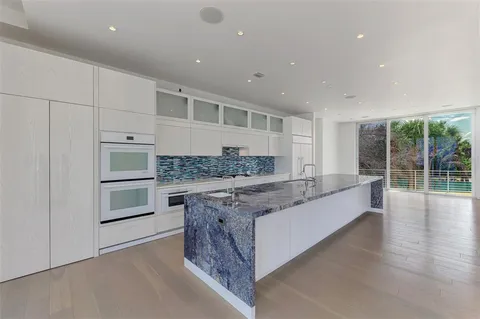 a kitchen with stainless steel appliances granite countertop a stove and a sink