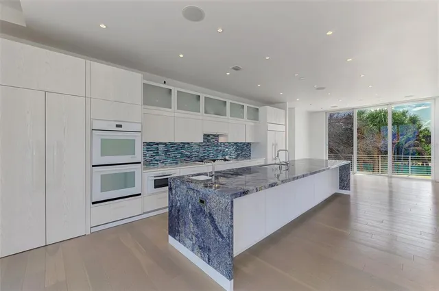 a kitchen with stainless steel appliances granite countertop a stove and a sink