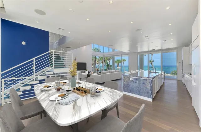 a living room with dining table and chairs