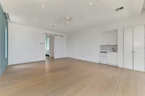 a view of empty room with wooden floor
