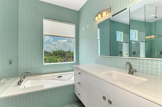 a bathroom with a bathtub and a sink