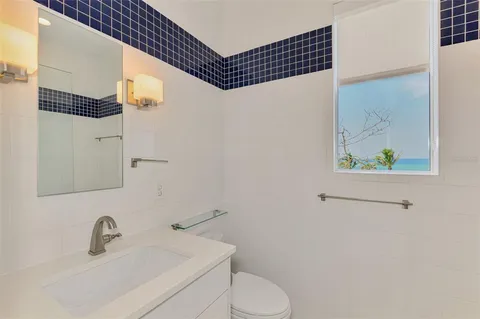 a bathroom with a sink toilet and mirror