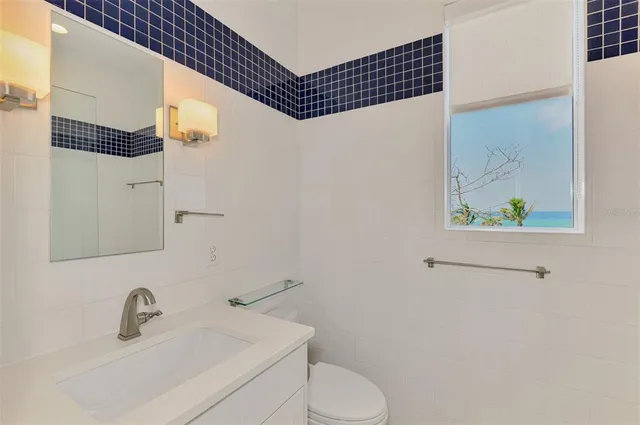a bathroom with a sink toilet and mirror