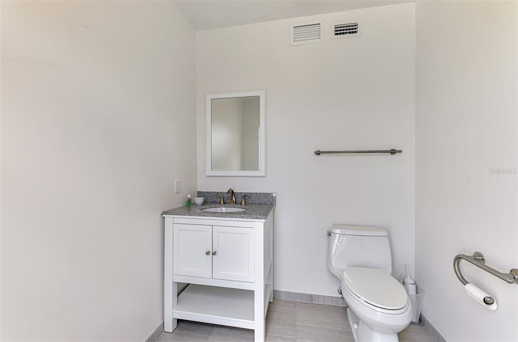 7410 Manasota Key Road Englewood, FL 34223 - Photo 39 of 45 a bathroom with a toilet a sink and mirror