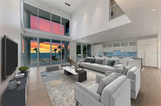 a living room with furniture a floor to ceiling window and flat screen tv