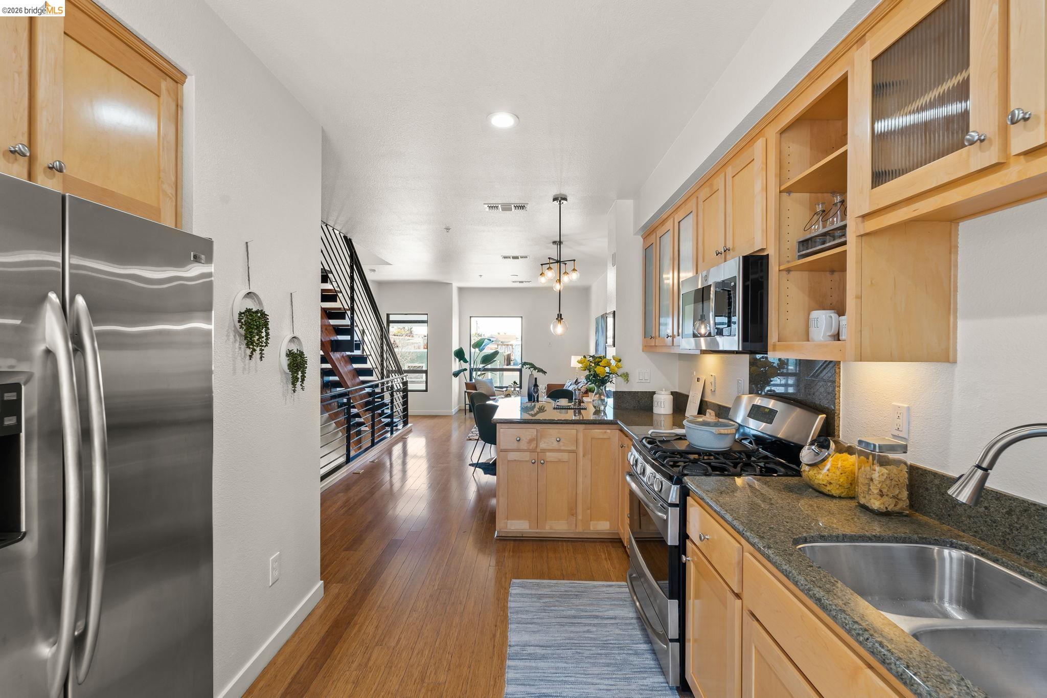 1780 12th Street Oakland, CA 94607 - Photo 7 of 31 a kitchen with counter top space a sink appliances and cabinets