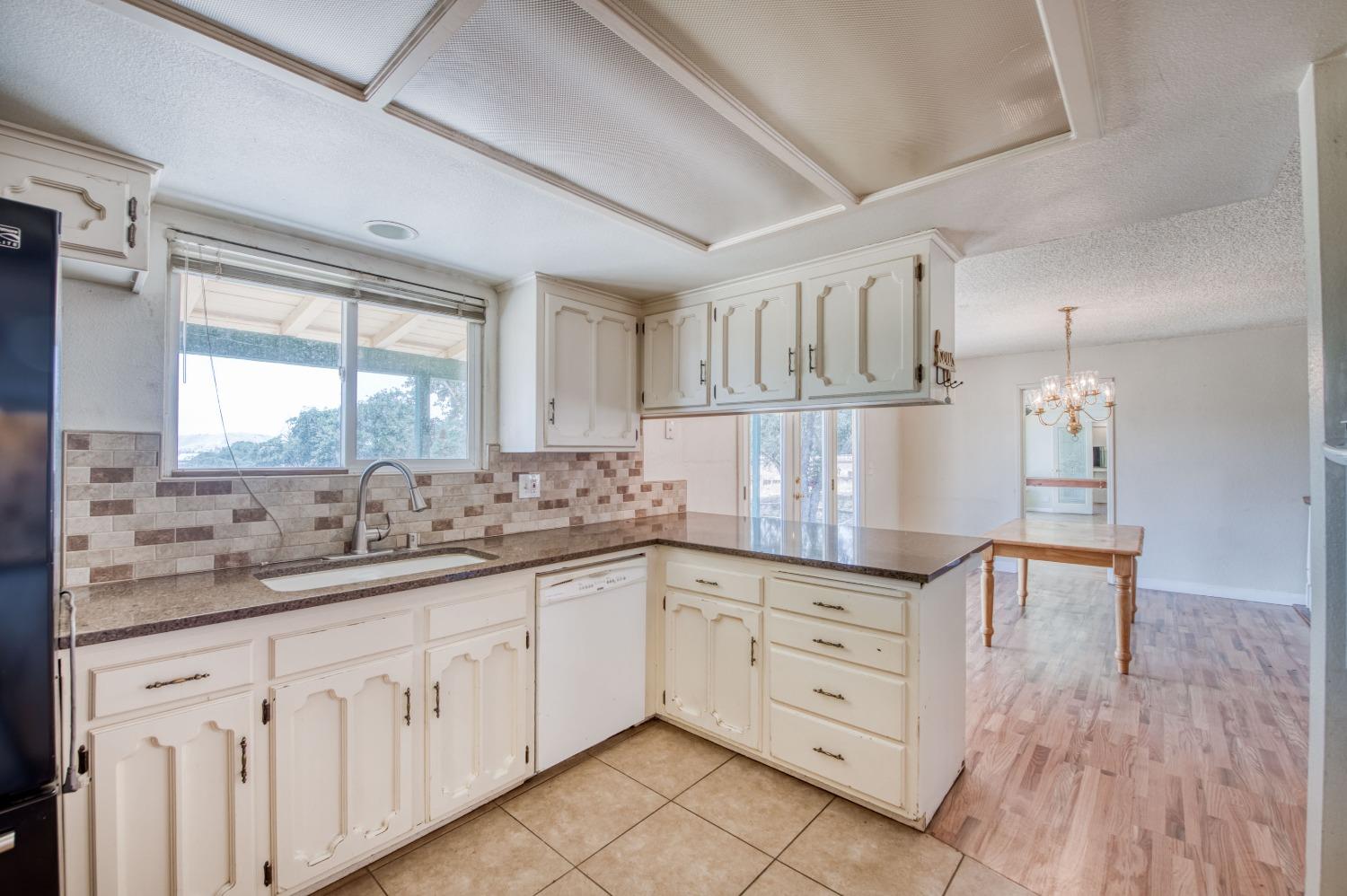 22452 Goldrush Lane Clovis, CA 93619 - Photo 11 of 36 a kitchen with cabinets appliances and a large window