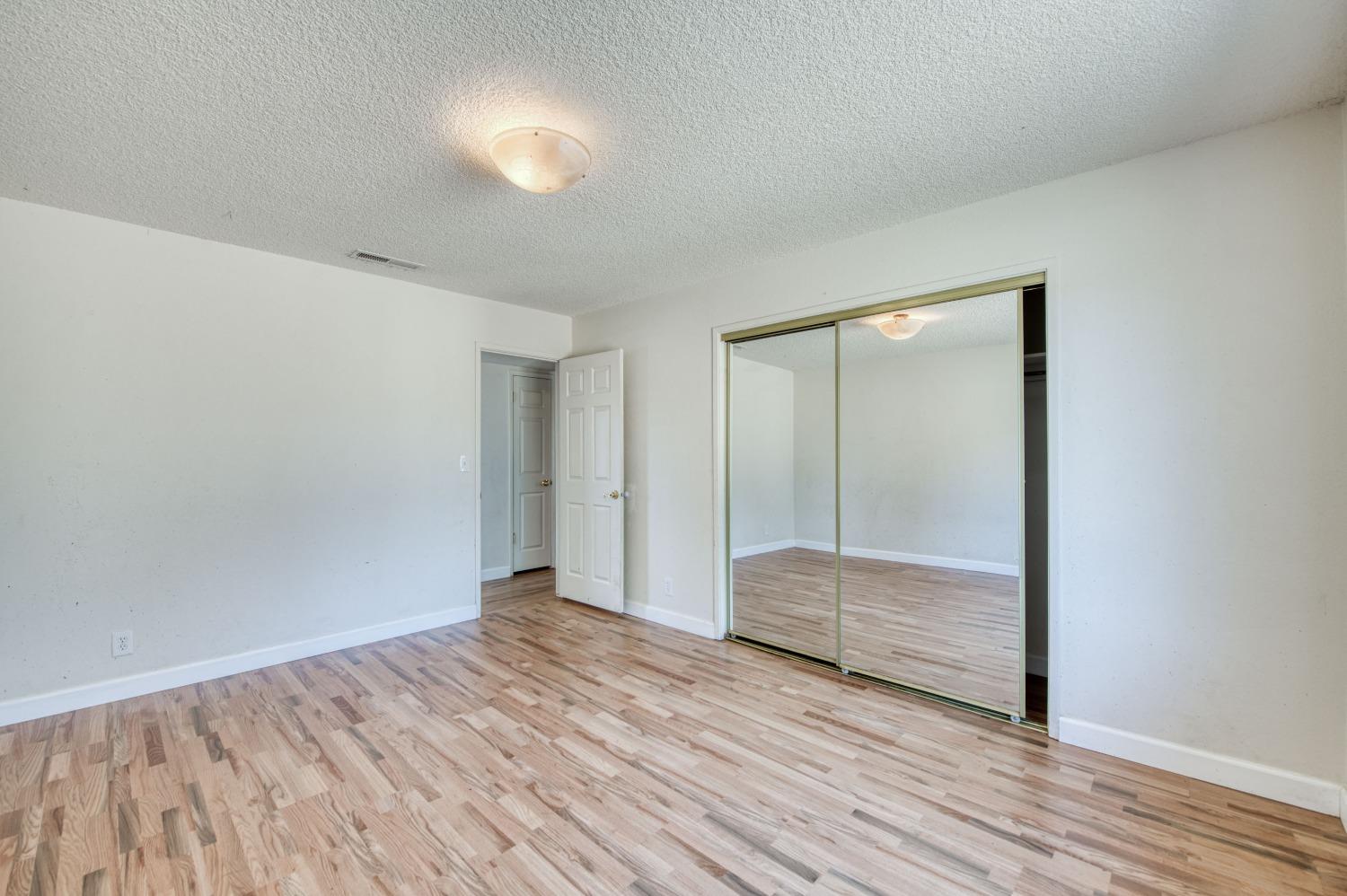 22452 Goldrush Lane Clovis, CA 93619 - Photo 18 of 36 a view of empty room with wooden floor