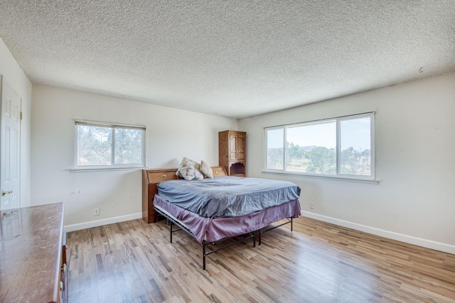 22452 Goldrush Lane Clovis, CA 93619 - Photo 21 of 36 a bedroom with a bed lamp and window