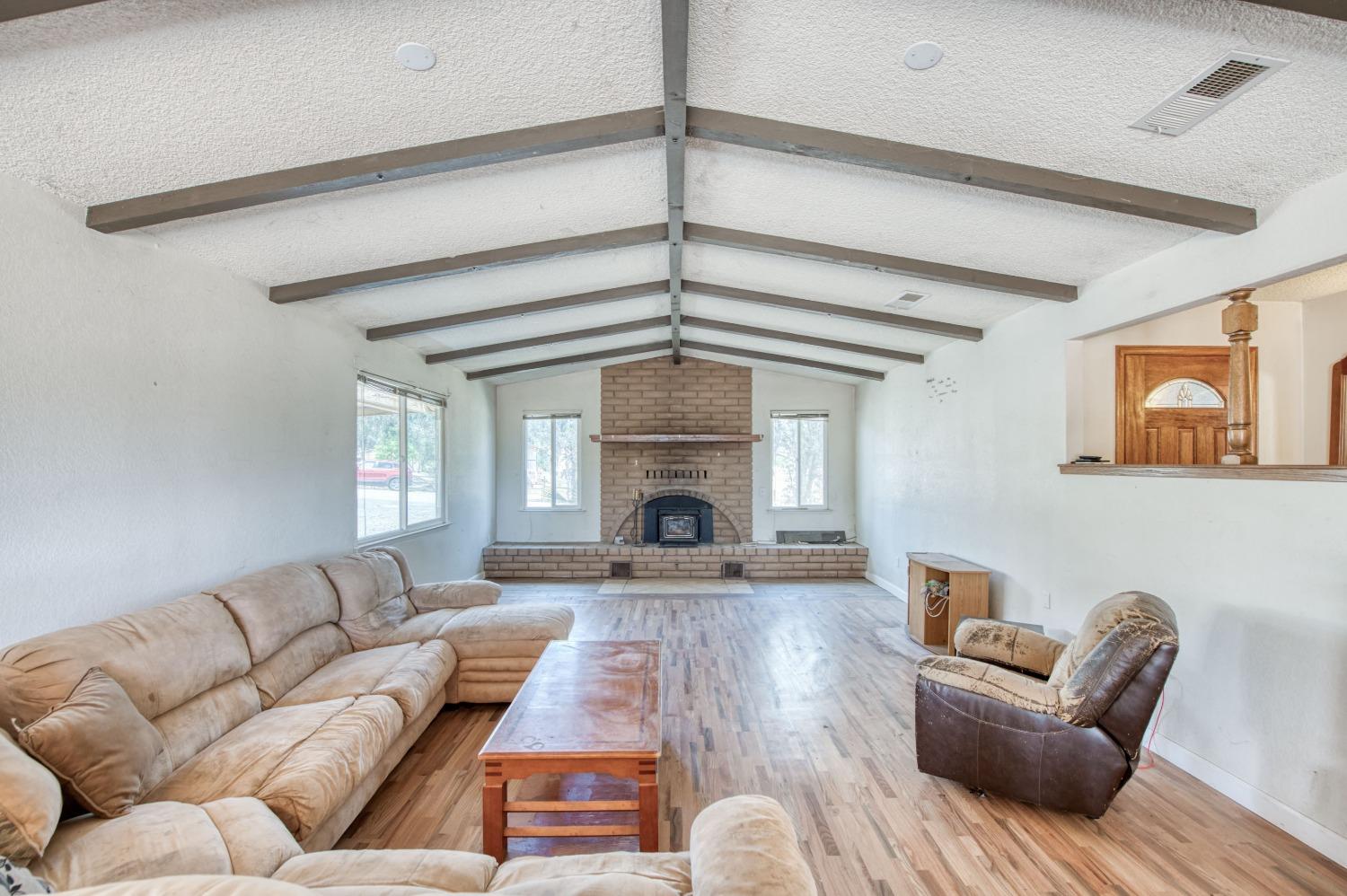 22452 Goldrush Lane Clovis, CA 93619 - Photo 3 of 36 a living room with furniture and a fireplace