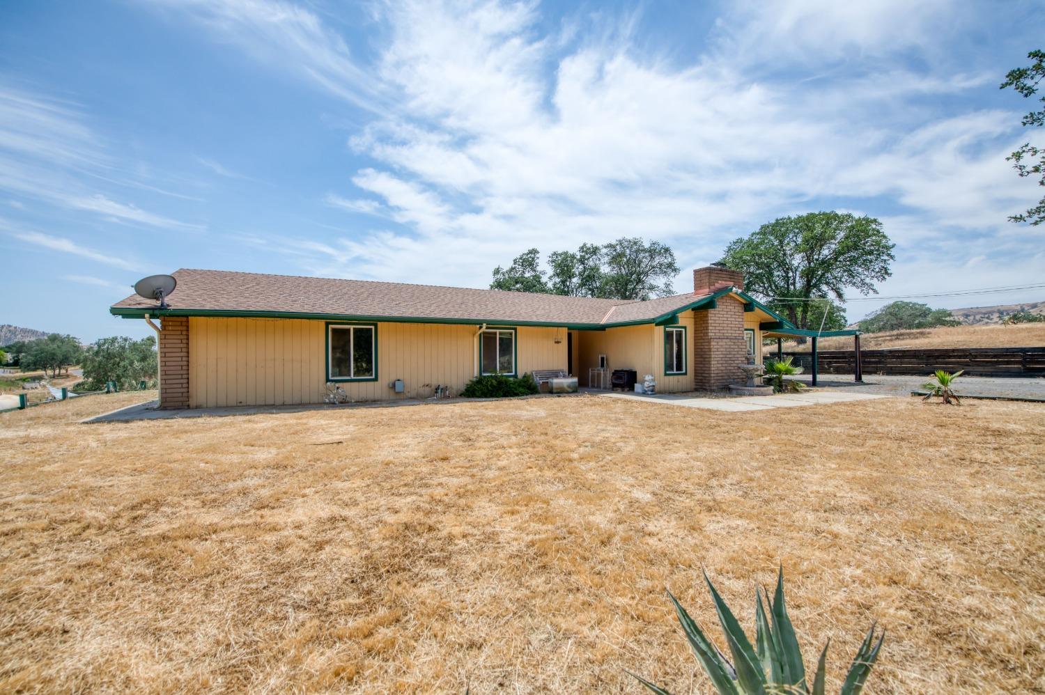 22452 Goldrush Lane Clovis, CA 93619 - Photo 36 of 36 a front view of a house with a yard and garage
