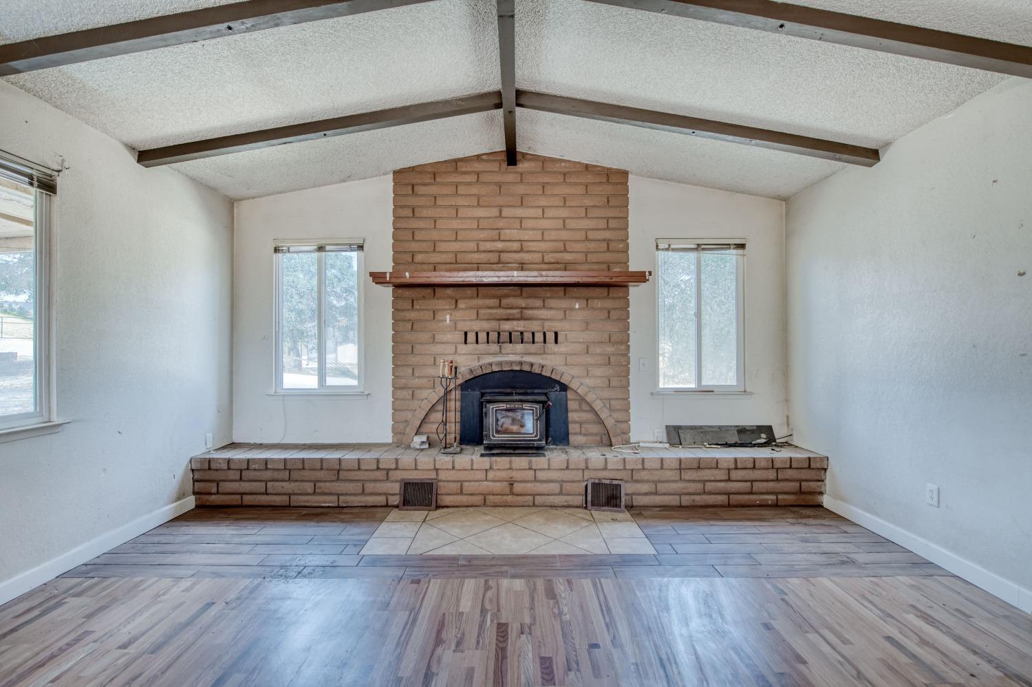 22452 Goldrush Lane Clovis, CA 93619 - Photo 4 of 36 a living room with furniture and a fireplace