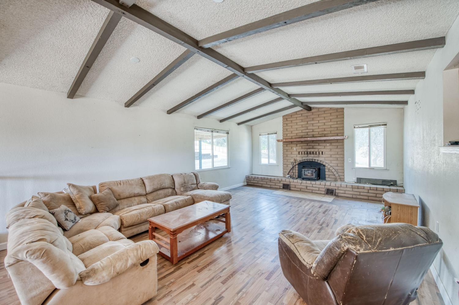22452 Goldrush Lane Clovis, CA 93619 - Photo 5 of 36 a living room with furniture and a fireplace
