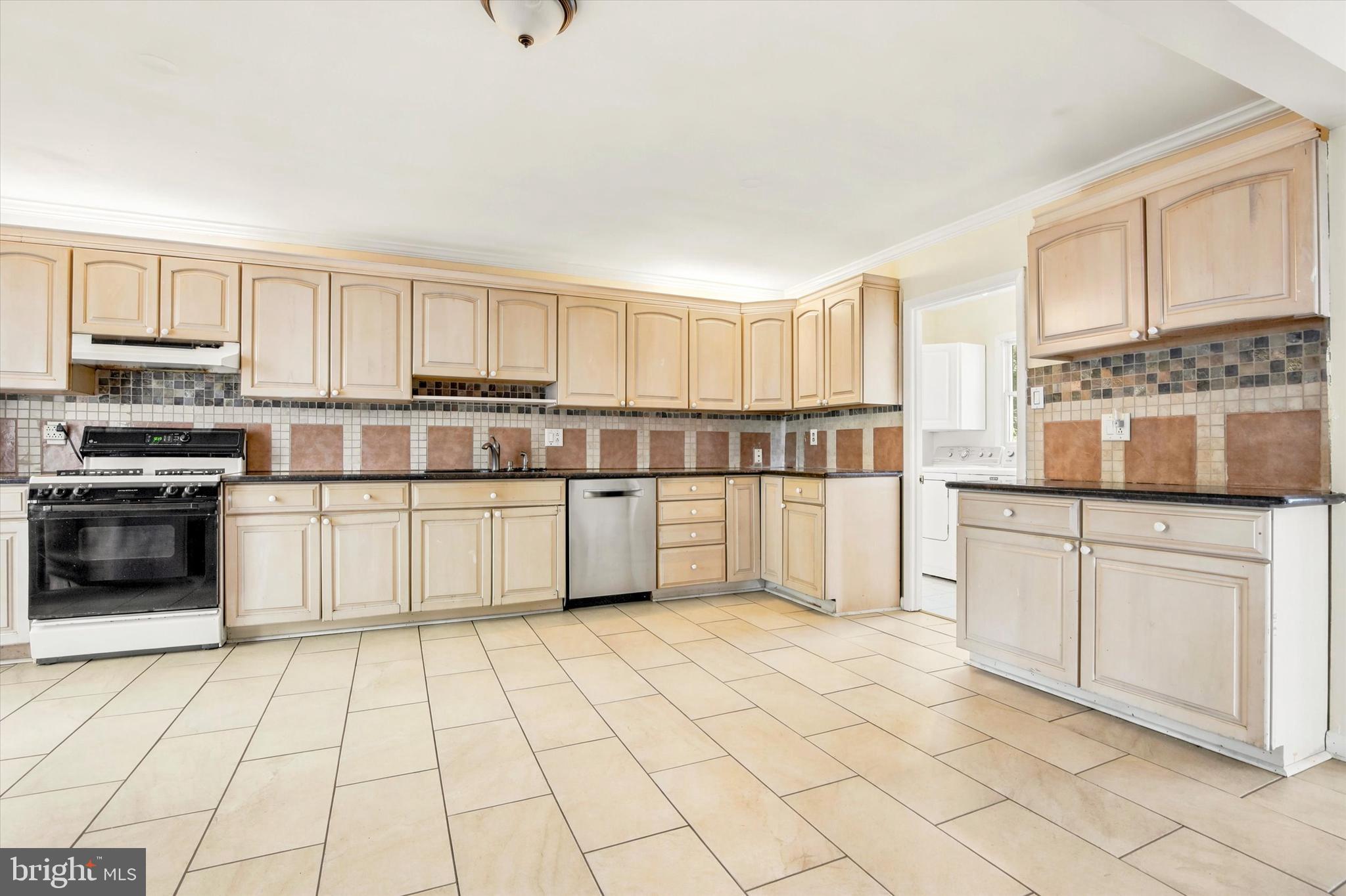 1167 Cushmore Road Southampton, PA 18966 - Photo 10 of 25 a kitchen with stainless steel appliances granite countertop a stove top oven a sink a counter top space and cabinets