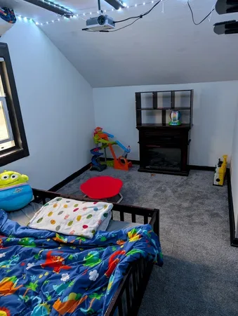 a view of play room with toys and dresser