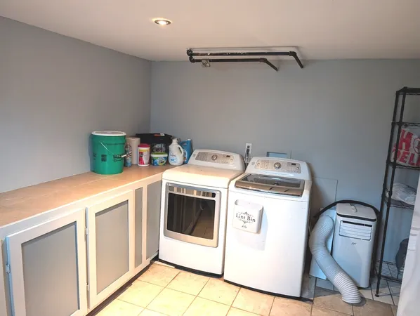 a room with a washing machine and washing machine