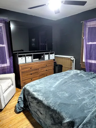 a bedroom with a bed and with furniture