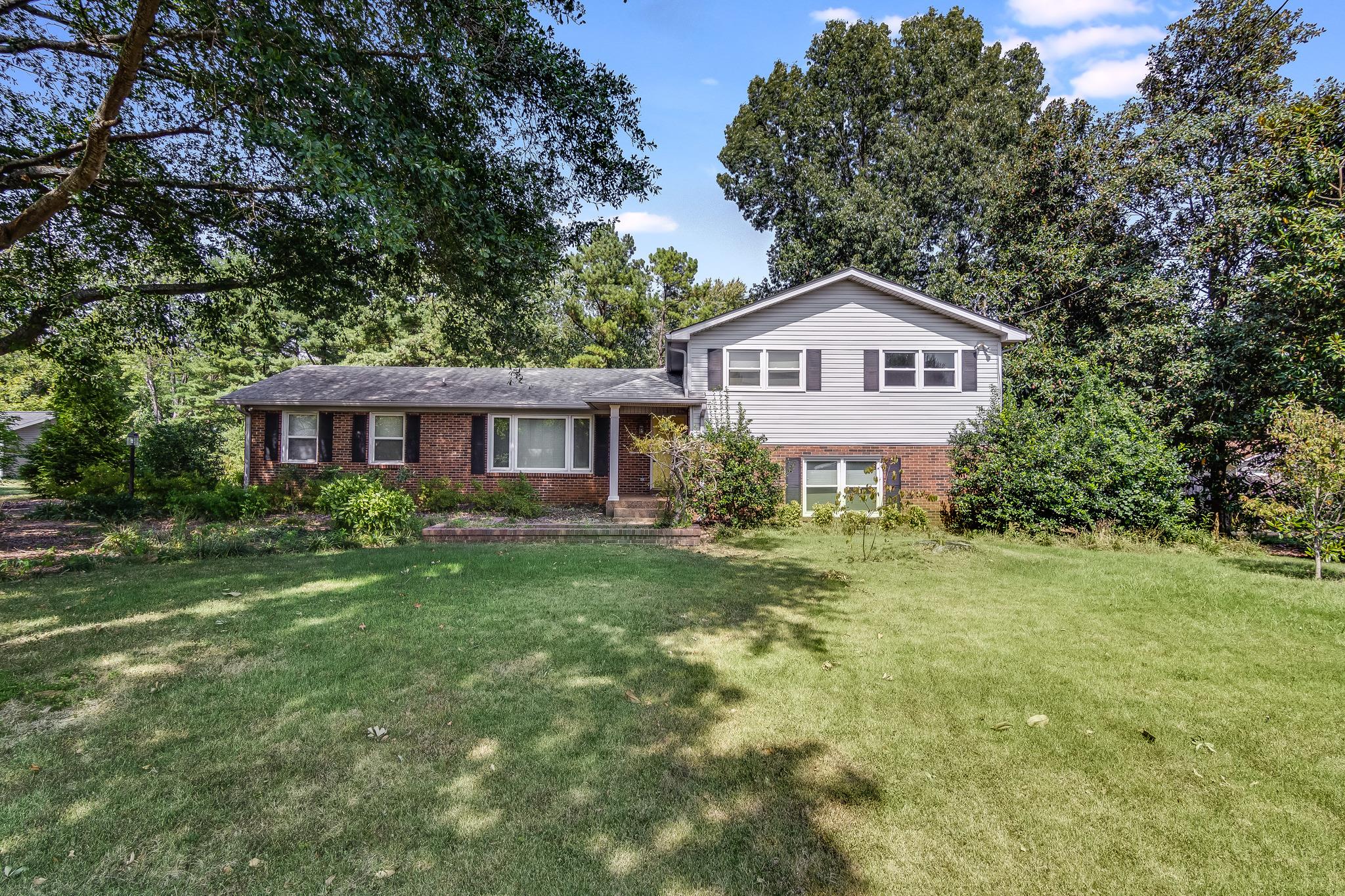 1518 Avon Road Murfreesboro, TN 37129 - Photo 3 of 22 a front view of a house with a yard and trees