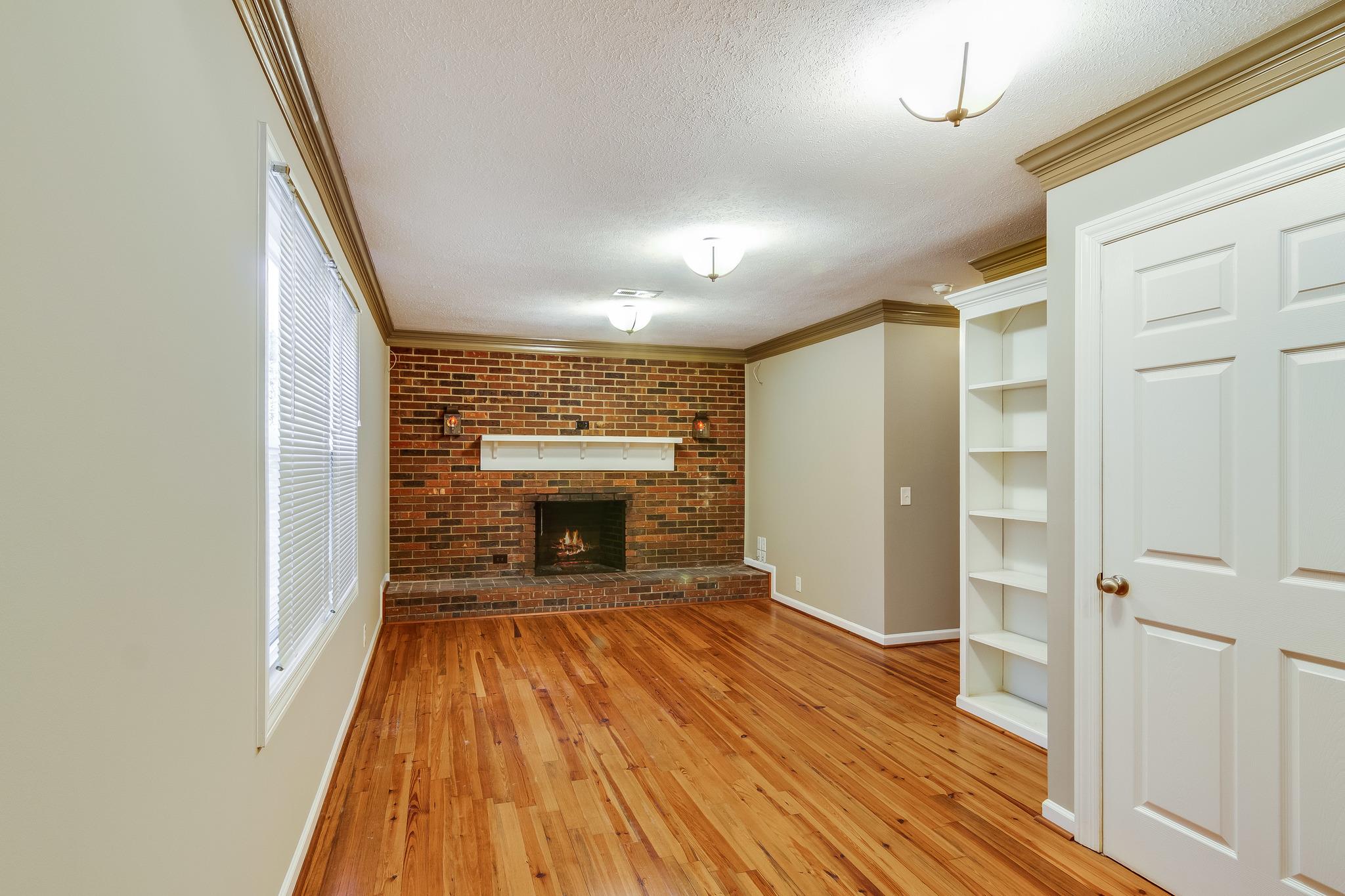 1518 Avon Road Murfreesboro, TN 37129 - Photo 9 of 22 wooden floor in an empty room with a fireplace