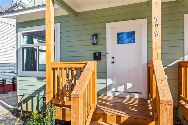 a front view of a house with wooden fence