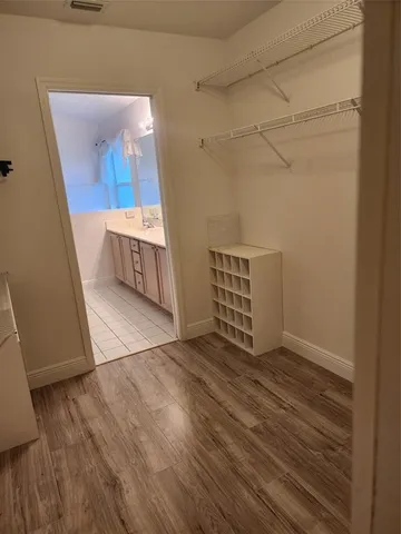 a view of a room with wooden floor and a sink