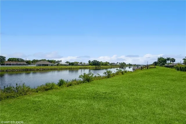 a view of a lake with houses in the back